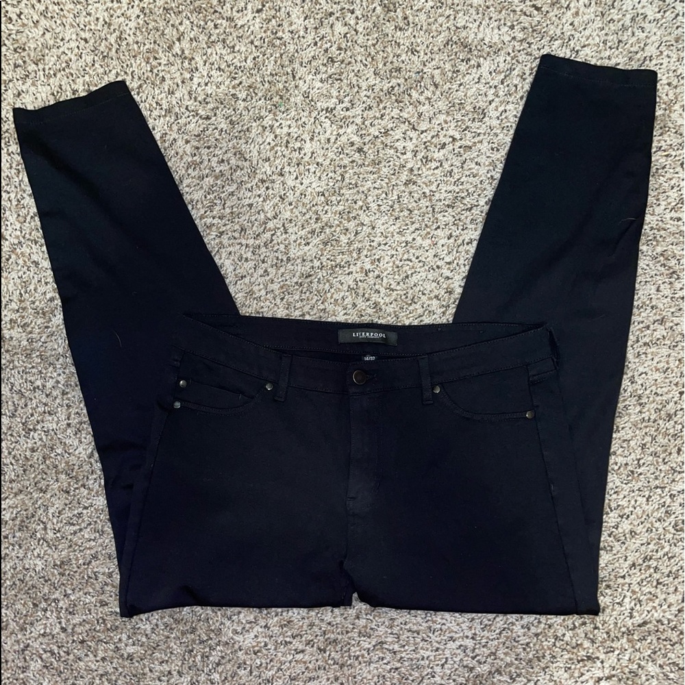 Simple black work jeans with pockets and no rips.